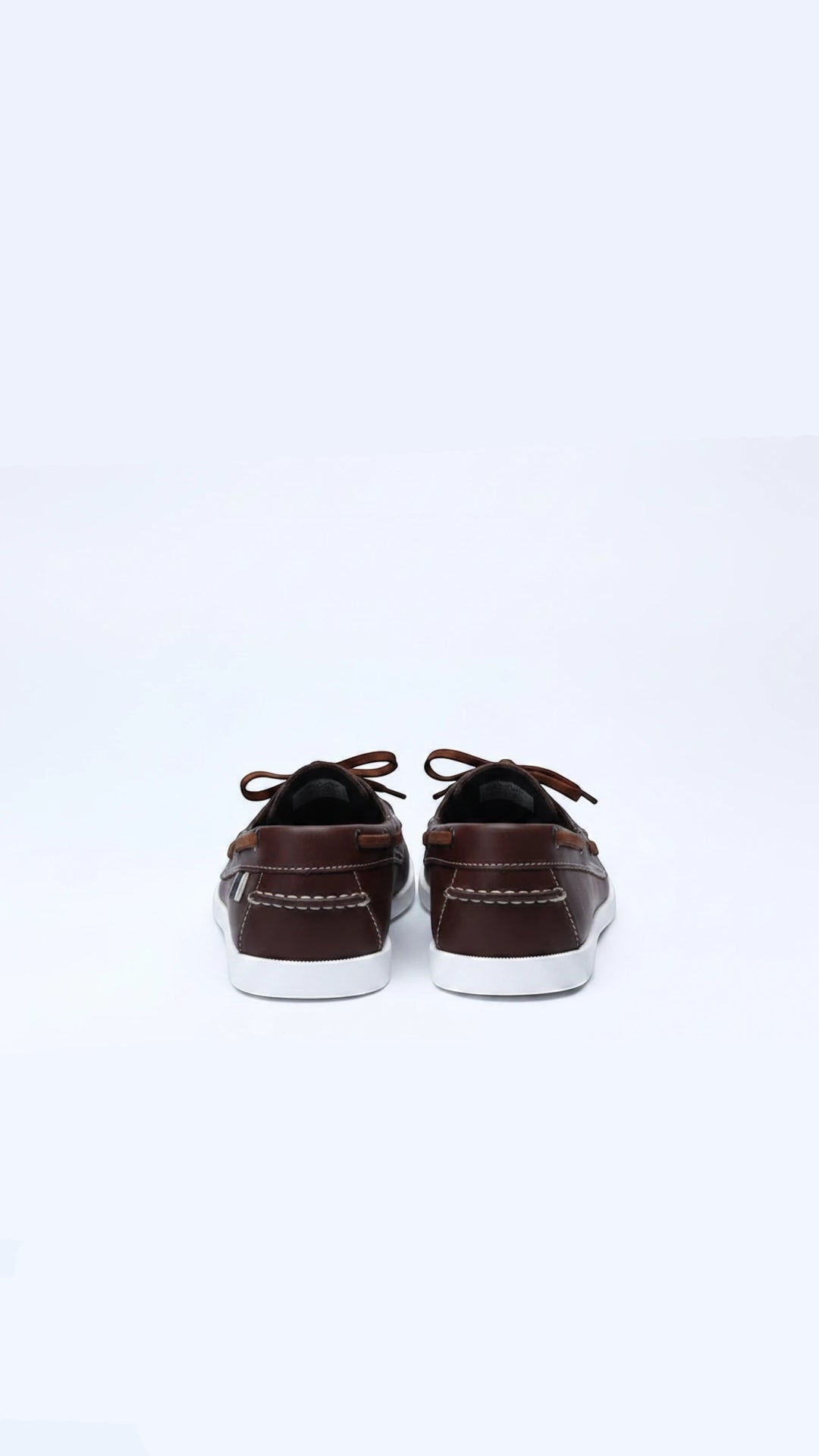 The Wool Company classic brown leather boat shoes with white contrast stitching and laces.