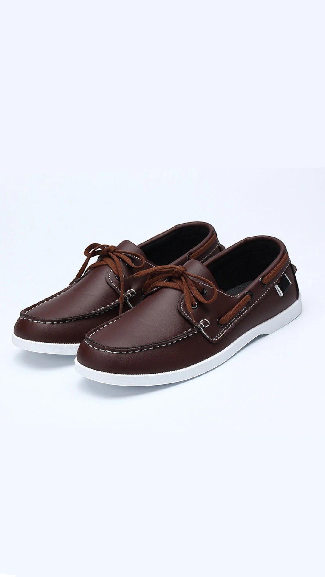 The Wool Company classic brown leather boat shoes with white contrast stitching and laces.